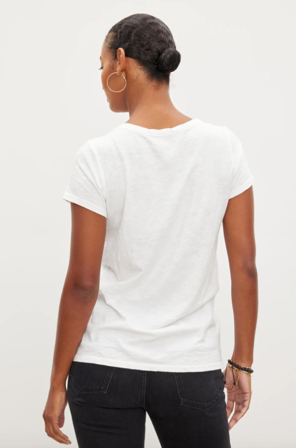 girl showing back of white s/s tee